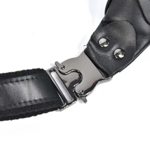 Detail shot of the tactical quick-release metal buckle and genuine leather strap of the chest bag.