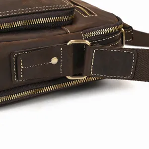 Detailed view of the cowhide shoulder bag showing durable stitching and sturdy metal hardware.