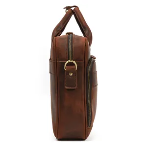 Side detail view of a men's genuine leather briefcase, retro business handbag and computer bag.