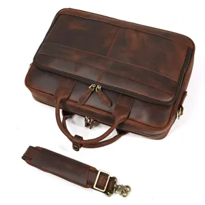 Detail view of retro men's genuine leather briefcase with metal zippers and strong strap.
