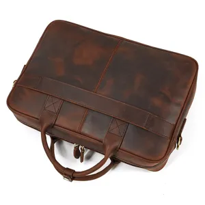 Close-up detail of vintage men's genuine leather briefcase, highlighting texture and hardware.
