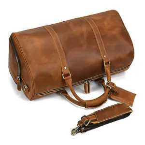 Vintage crazy horse leather travel duffel bag detail showing premium brown leather texture.
