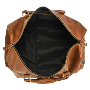 Detailed top view of vintage leather duffel bag interior, spacious lining with zipper pocket.