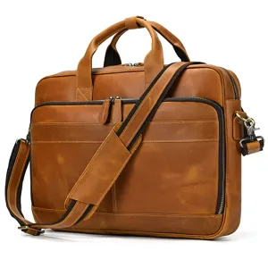 Close-up detail of retro brown leather business briefcase with sturdy handles and zippers.