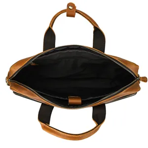 Detailed view of the premium leather business briefcase interior compartment and sturdy dual handles.