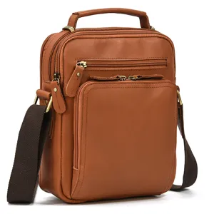 Close-up detail of the brown leather men's crossbody bag featuring multiple zippers.