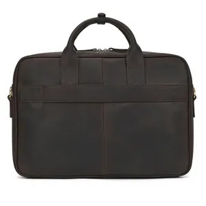 Close-up detail of vintage dark brown leather briefcase handle and stitching craftsmanship.