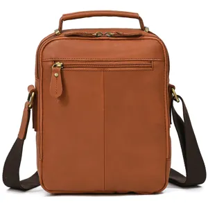 Detailed view of the brown leather messenger bag featuring durable zippers and handle.