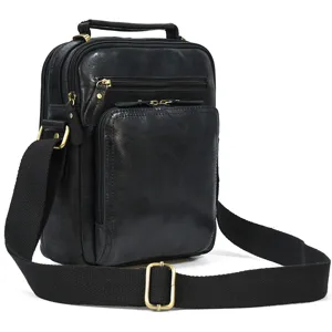 Close-up detail of men's genuine leather shoulder bag featuring multiple zippered pockets.