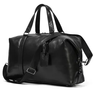 Large capacity leather travel duffel bag with sturdy handles and adjustable shoulder strap.