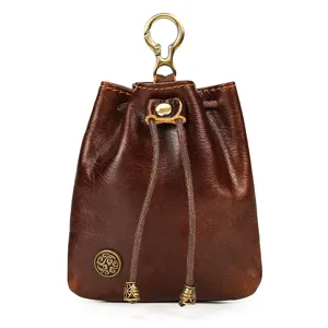 Detailed view of retro vegetable-tanned leather coin purse, featuring metal clasp and drawstring.