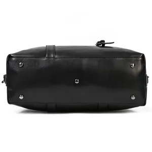 Genuine leather travel duffel bag bottom view, showing durable metal feet and neat stitching.