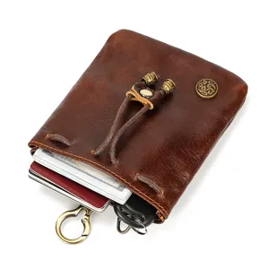 Vintage dark brown leather coin purse mini wallet with drawstring and metal clasp closure.