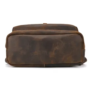 Vintage crazy horse leather men backpack bottom detail view showing durable genuine material.