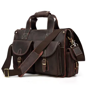 Vintage brown leather bag detail, multi-pocket design, durable metal hardware and shoulder strap.