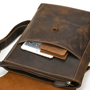 Detailed view of brown crazy horse leather messenger bag with front pocket and zipper.