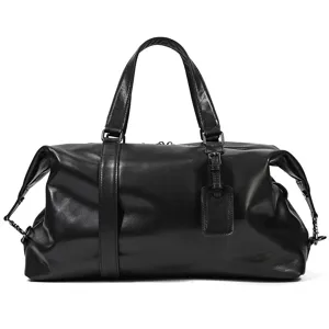 Detailed shot of black leather travel duffle bag, premium texture and double handles.