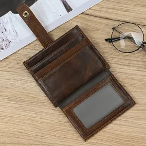 Closeup of vintage brown leather card holder wallet with multiple slots and photo ID window.