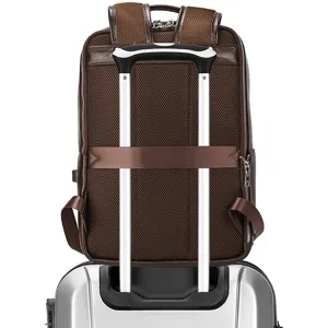 Detail view of brown genuine leather business backpack with luggage strap and mesh back panel.