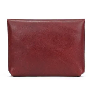 Genuine leather snap coin purse detail close up showing smooth wine red cowhide texture.