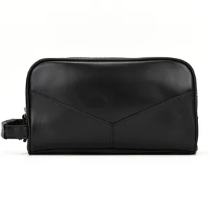 Black genuine leather toiletry bag with side handle and classic V-stitch envelope design.