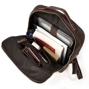 Detailed interior view of vintage genuine leather backpack showcasing large capacity laptop compartment.