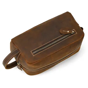 Detailed close-up view of genuine leather toiletry bag zipper and handle craftsmanship.