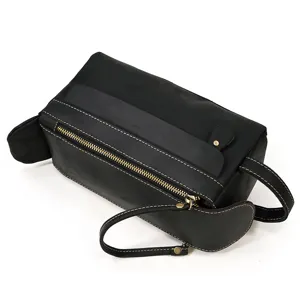 Black genuine leather toiletry bag detail view, vintage travel wash bag with metal zipper.