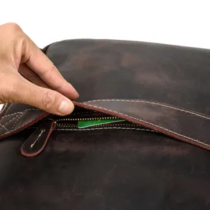 Close-up detail shot of vintage crazy horse leather backpack zipper pocket and texture.