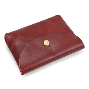 Genuine leather snap coin purse detail view showing fine texture and brass button closure.