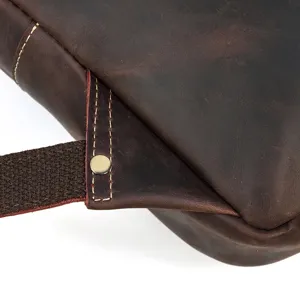Close-up detail of vintage crazy horse leather backpack strap and stitching craftsmanship.