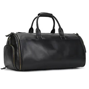 Black leather travel duffel bag detail showing fine texture, durable metal zippers.