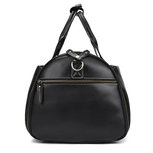 Vintage black leather travel bag with dual top handles, spacious design and durable hardware.