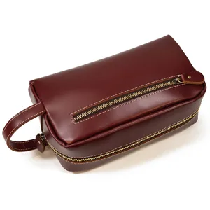 Close-up of genuine leather toiletry bag zipper detail and retro texture for travel.