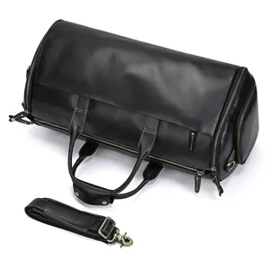 Detailed close-up view of a black genuine leather travel duffel bag with shoulder strap.