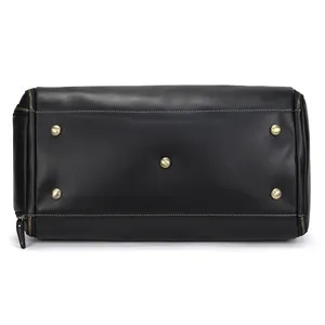 Black leather travel bag bottom detail with sturdy metal feet and strong zippers for daily use.
