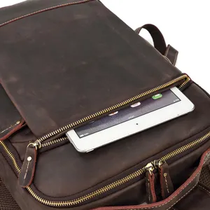 Detail view of vintage crazy horse leather backpack front zipper pocket with tablet storage.