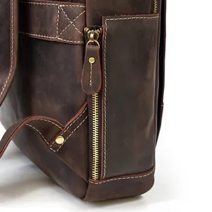 Close-up detail of the vintage brown crazy horse leather backpack side zipper and fine stitching.
