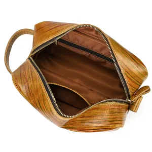 Genuine leather toiletry bag interior detail view, vintage makeup pouch with side handle.
