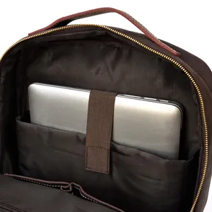 Genuine leather backpack interior detail featuring padded laptop compartment and secure strap.