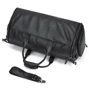 Black leather travel duffel bag detail showcasing sturdy handles and smooth zippers.