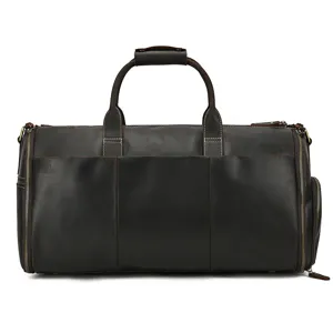 Dark brown leather travel duffel bag detail, premium vintage luggage with sturdy metal zippers.