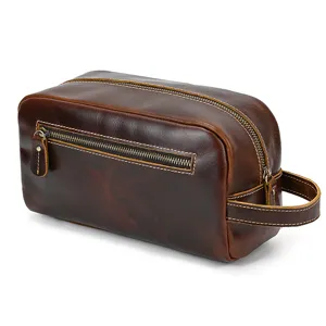 Detailed view of the vintage genuine leather toiletry bag with zipper and side handle.