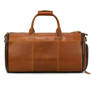 Detail view of the brown leather duffel bag showcasing side zipper pocket and sturdy top handles.