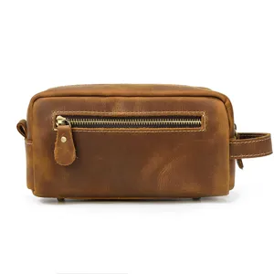 Vintage leather toiletry bag detail view, premium brown cosmetic storage pouch for men.