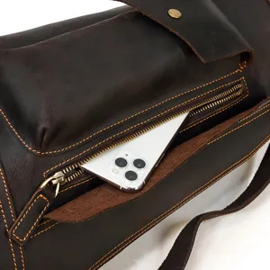 Close-up detail shot of vintage crazy horse leather chest bag zipper pocket storage.
