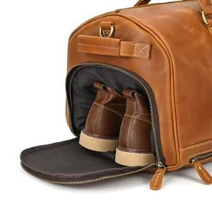 Genuine leather travel duffel bag detail showcasing independent shoe compartment design.
