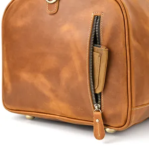 Detailed view of vintage crazy horse leather travel bag side pocket with durable metal hardware.