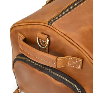 Vintage crazy horse leather travel duffel bag detail showing durable stitching and zippers.