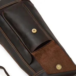 Close-up detail of vintage crazy horse leather chest bag showing textured cowhide and stitching.